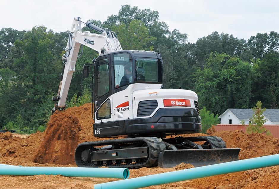 Bobcat E85 compact excavator on a Jim Meyers Plumbing job site, ready to dig in next to new sewer pipe